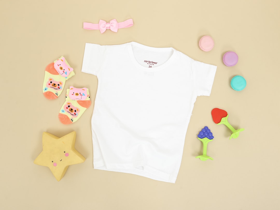 Home A small white shirt for a baby. Flatlay mockup for showcasing your apparel design for child clothes.